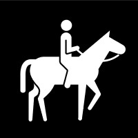 Svartvit bildstödssymbol där en person rider på en häst